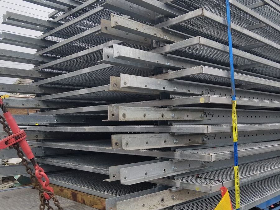 Oversize steel bundle chained down with an oversize load flag.